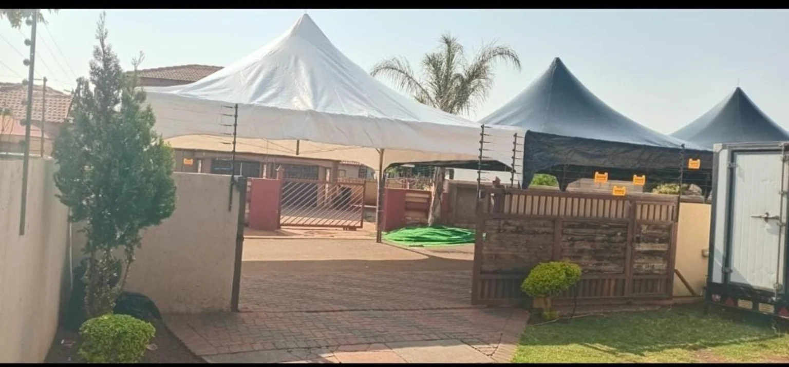 Marquee structures arranged for an outdoor event, showing the preparation and logistical detail behind a beautiful venue.