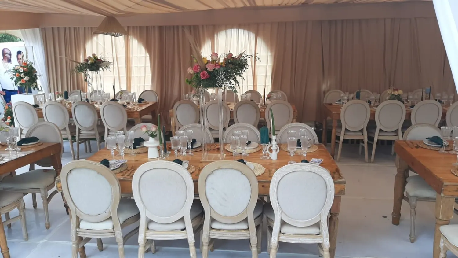 Actual reception styled with cream chairs and floral centrepieces