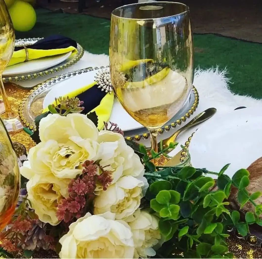 Cream & Gold Touches. Gentle florals and shimmering glassware elevate a perfectly styled tabletop.