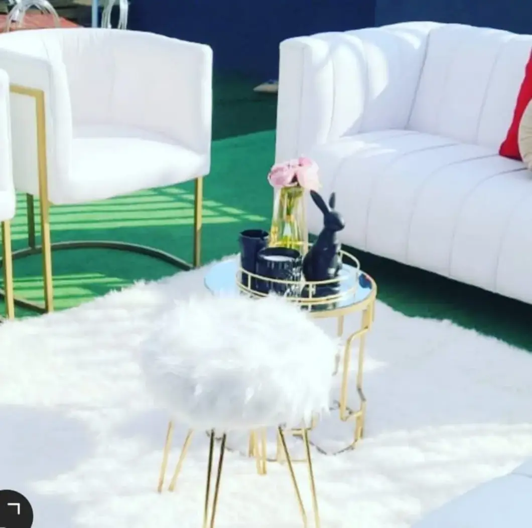 White Lounge Retreat. Comfortable ivory seating and elegant finishing touches invite guests to stay a little longer.