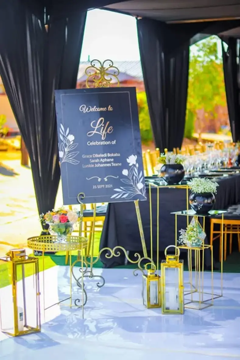 Thoughtful Welcome Display. A composed arrangement with gold details, florals and carefully arranged signage.