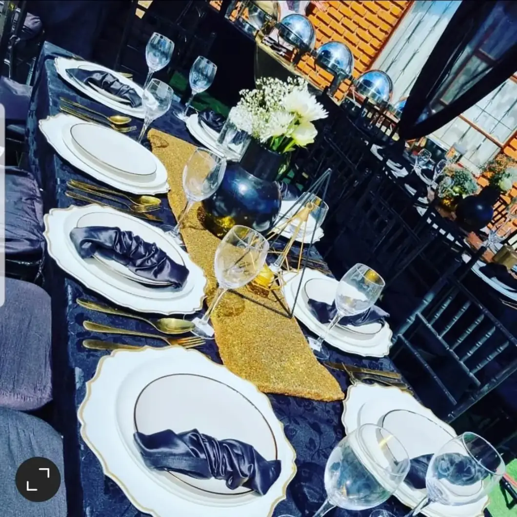 Black Tie Styling. Fine glassware, white blooms and layered black-and-gold details bring a timeless sophistication.